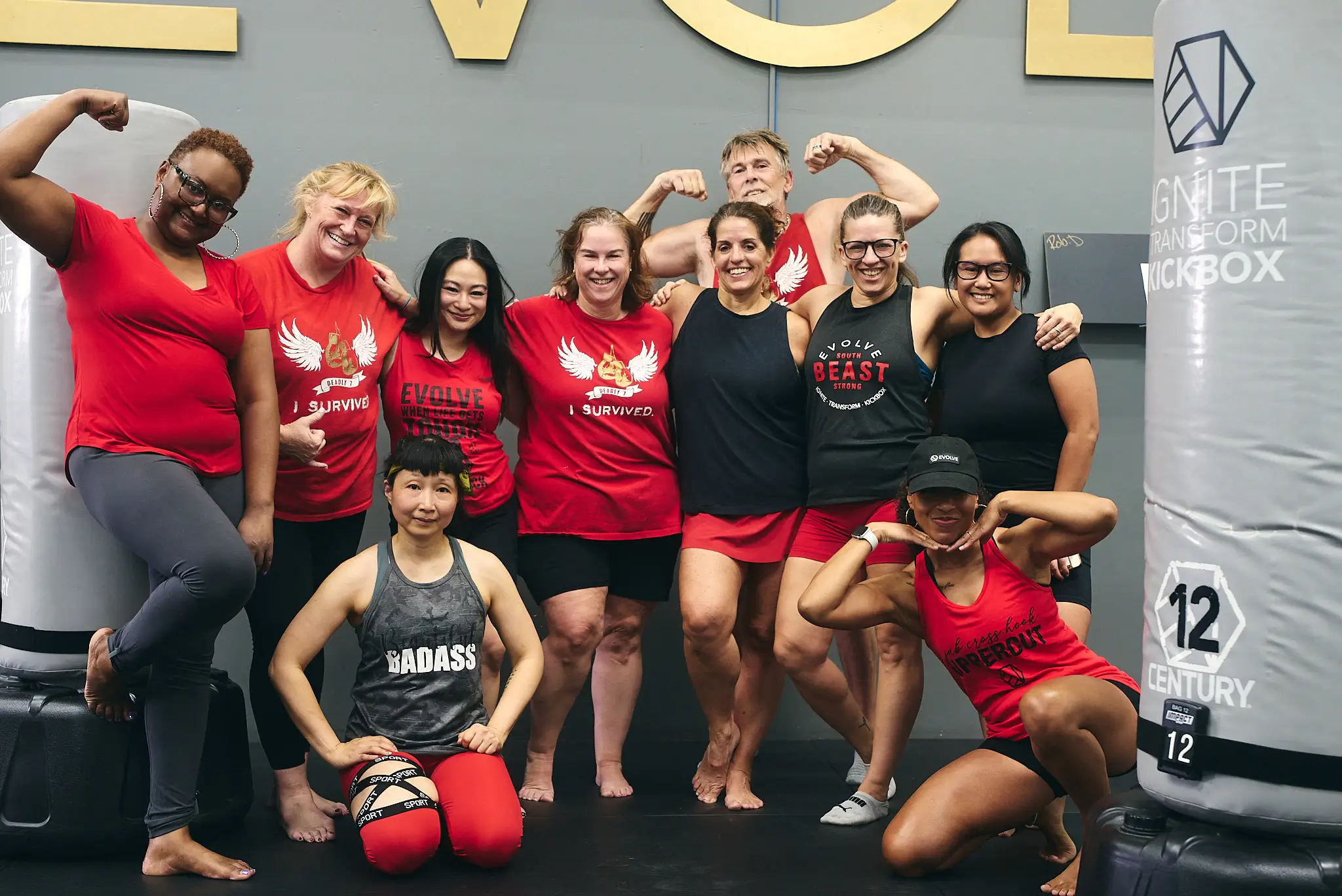 Group of women celebrating after a kickboxing and strength training session at Evolve Kickbox & Fitness, a supportive women’s gym in Las Vegas offering structured fitness classes.