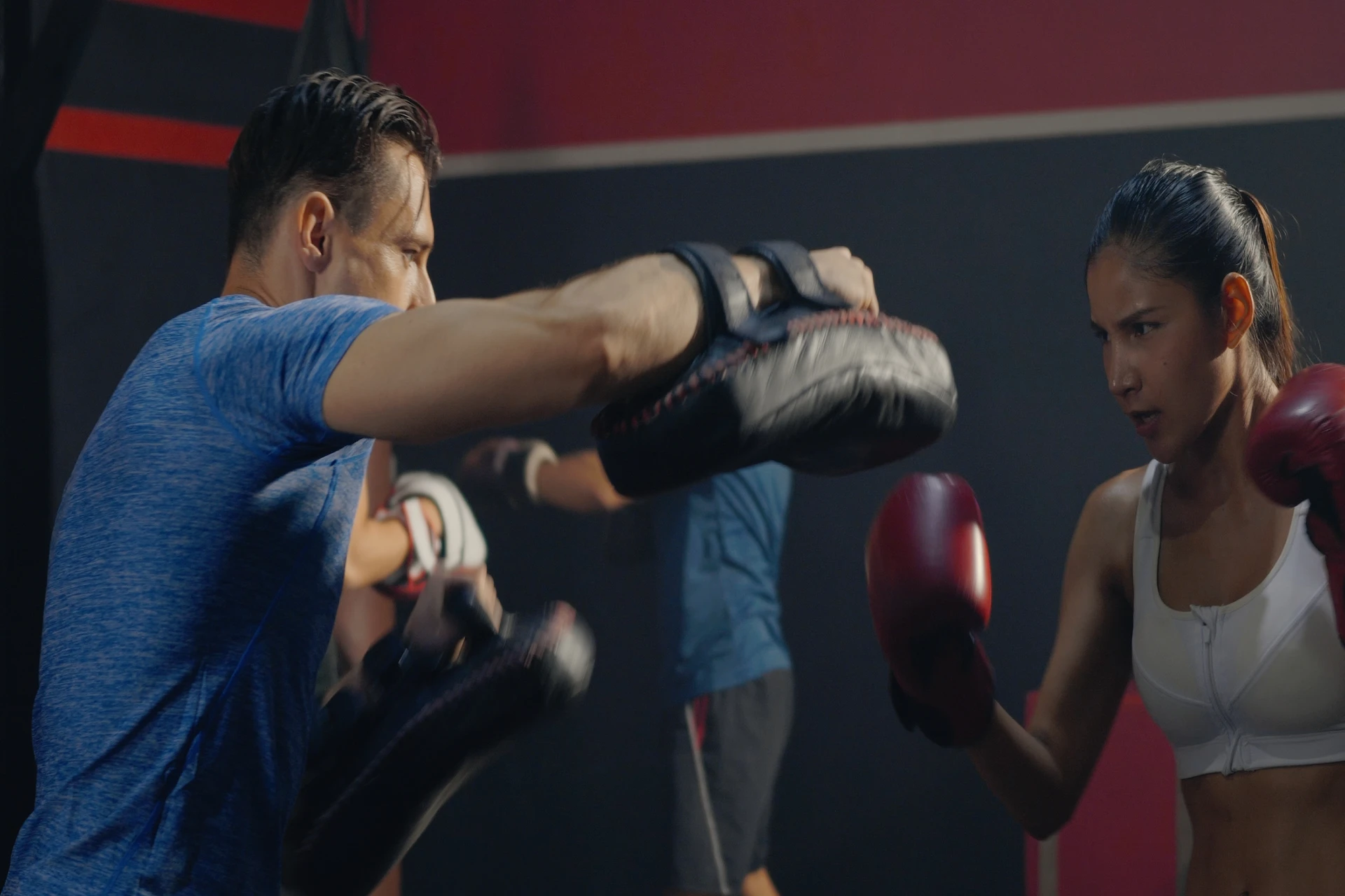A member works one-on-one with a trainer during fitness classes in Las Vegas at Evolve Kickbox & Fitness, showing real progress and support at a fitness gym.
