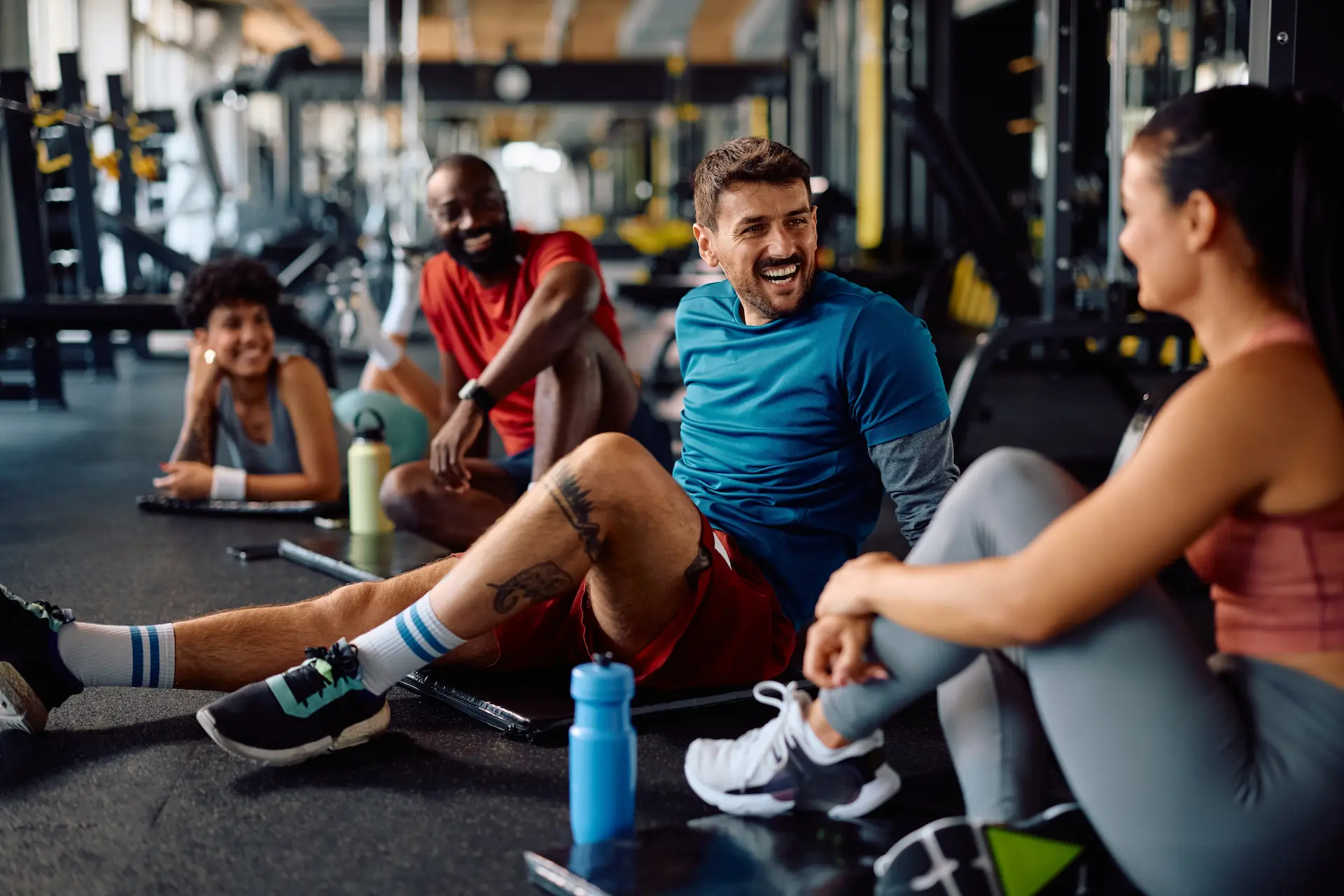 Supportive fitness community during strength training in Las Vegas with members participating in weight lifting classes in a gym setting